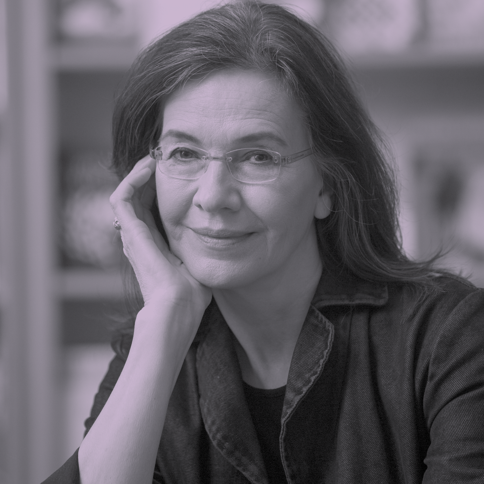 Black and white photo of Louise Erdrich. She is seated with her head resting in her right palm.
