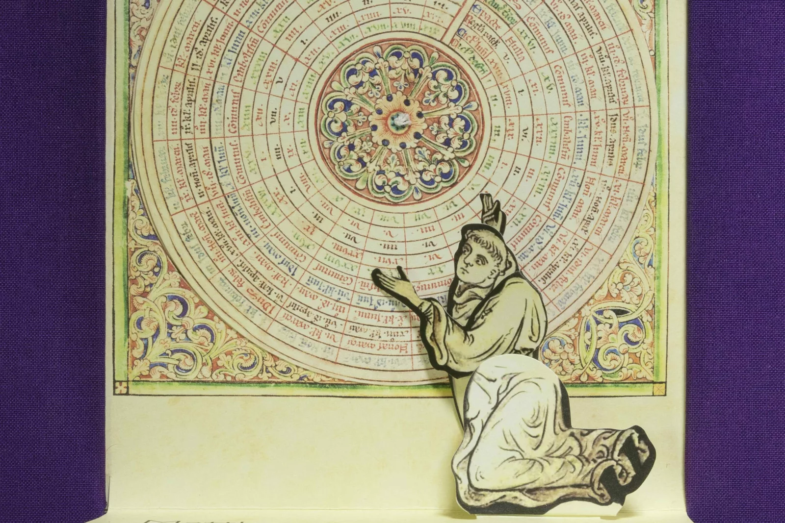 A monk kneels in front of concentric circles.