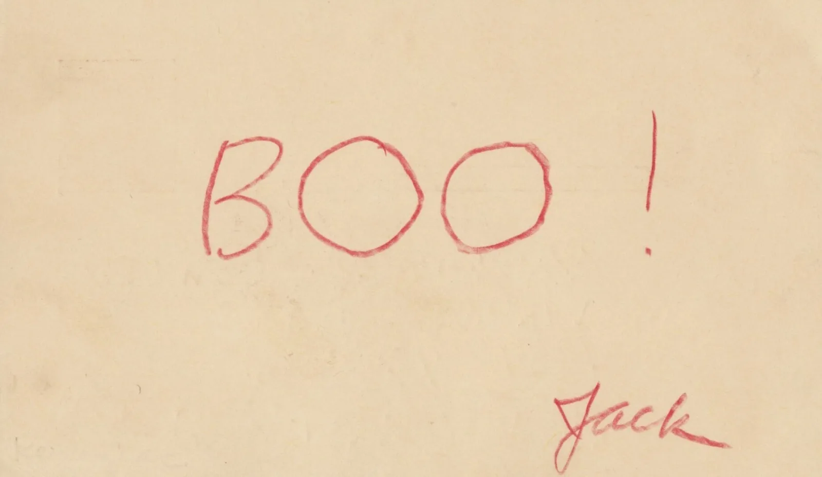 Boo! The word “Boo!” is written in all caps in red pencil. Underneath the word is the name “Jack” signed in cursive by Jack Kerouac.
