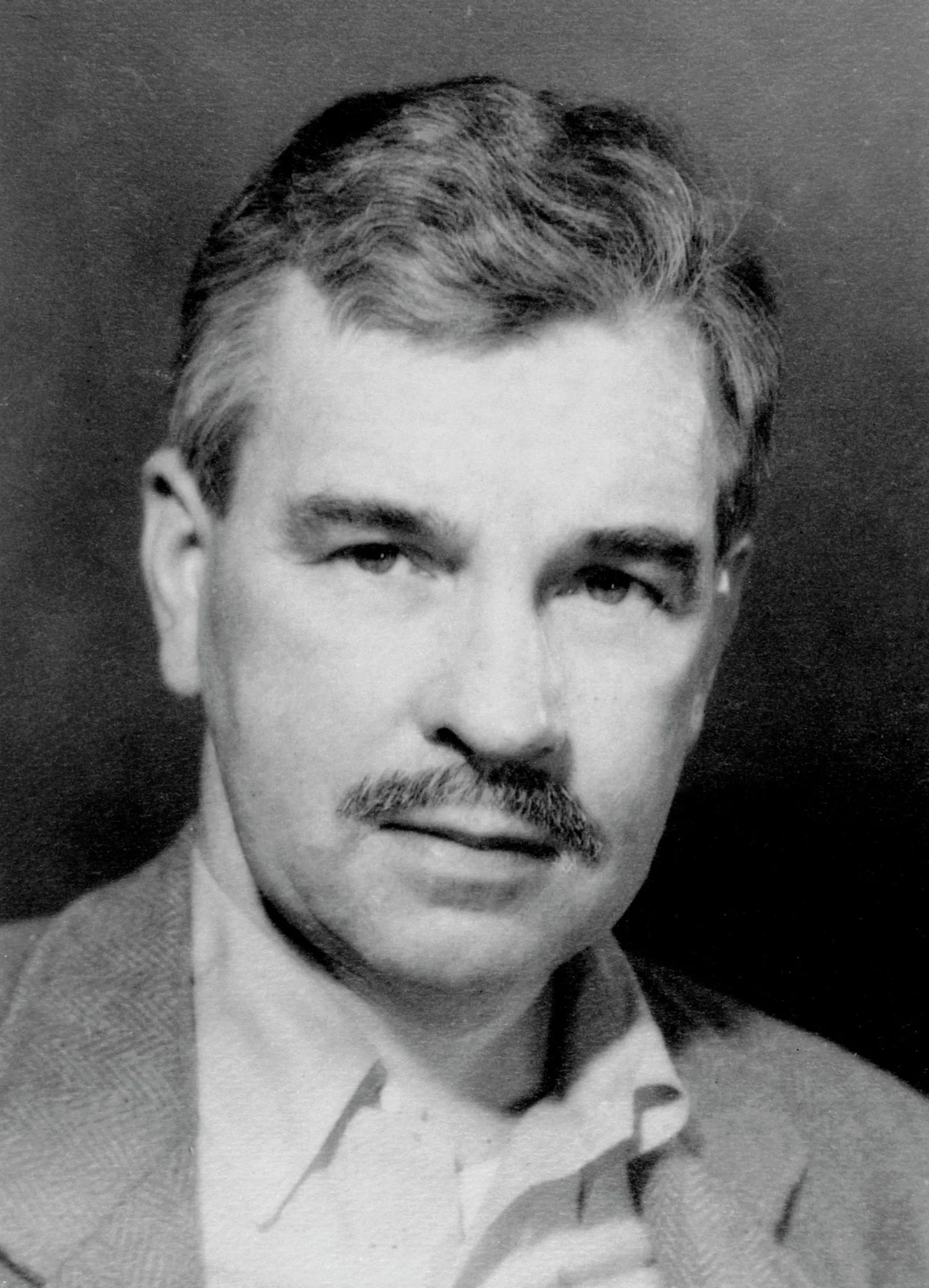 Malcolm Cowley wears an open-collar shirt and a sport coat.