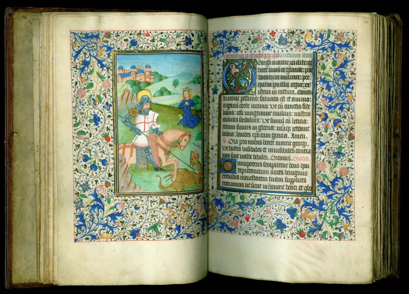 Saint George and the dragon. A soldier wearing medieval armor sits on a horse and stabs a dragon with a lance.