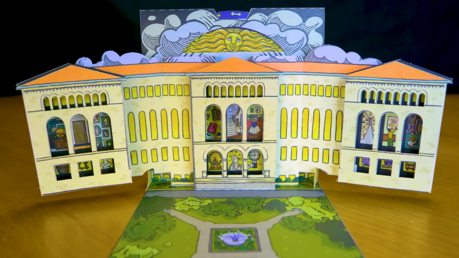 A pop-up book version of the Newberry Library mimics the library’s architecture. Details related to the Newberry are visible inside the windows of the three-dimensional paper sculpture.