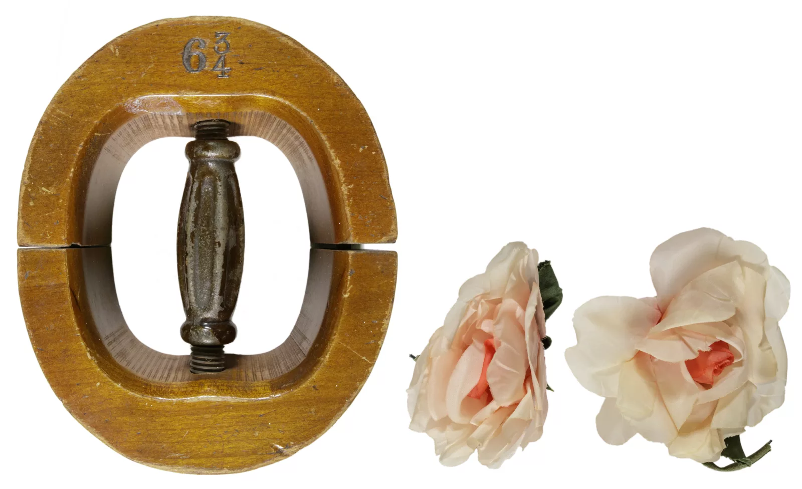 Eunice’s wooden hat stretcher and pink decorative flowers that she used in her millinery.