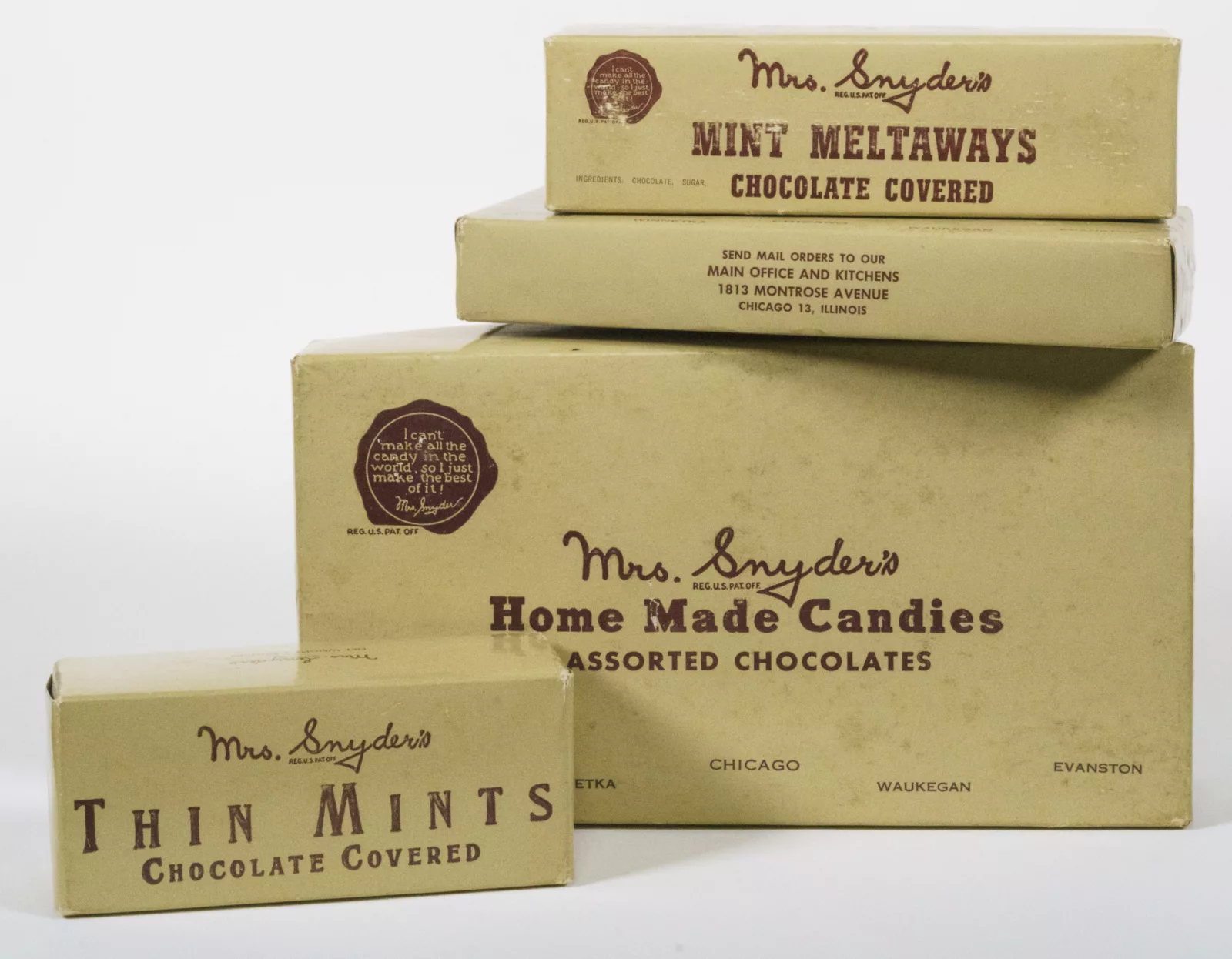 Candy boxes from Mrs. Snyder's Home Candies are stacked on top of each other.