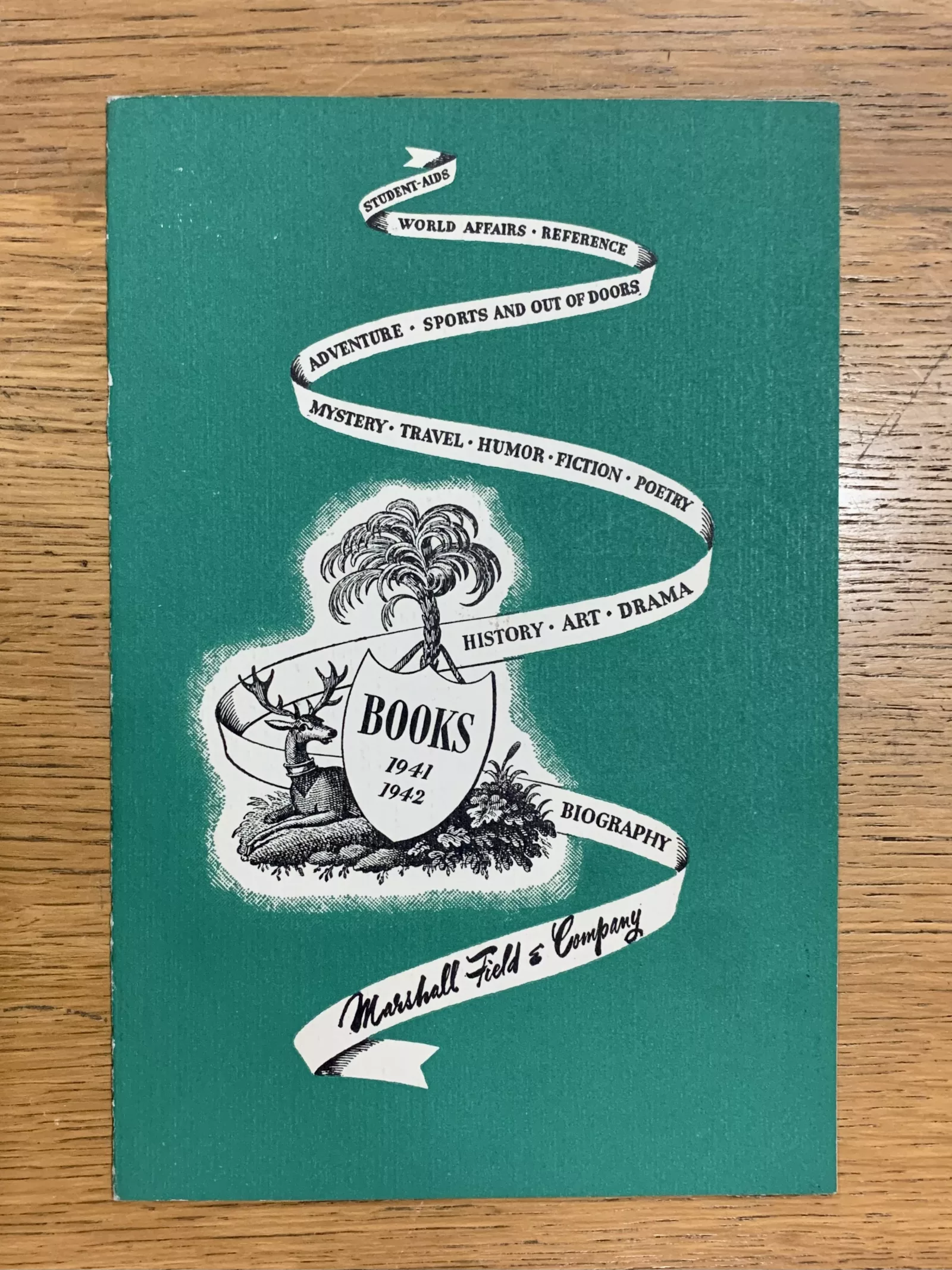 Promotional material Hayes created for the Marshall Field & Company on green card stock. The piece reads, "Books 1941-1942. Student aids, world affairs, reference, adventure, sports and out of doors, mystery, travel, humor, fiction, poetry, history, art, drama, biography. Marshall Field & Company."