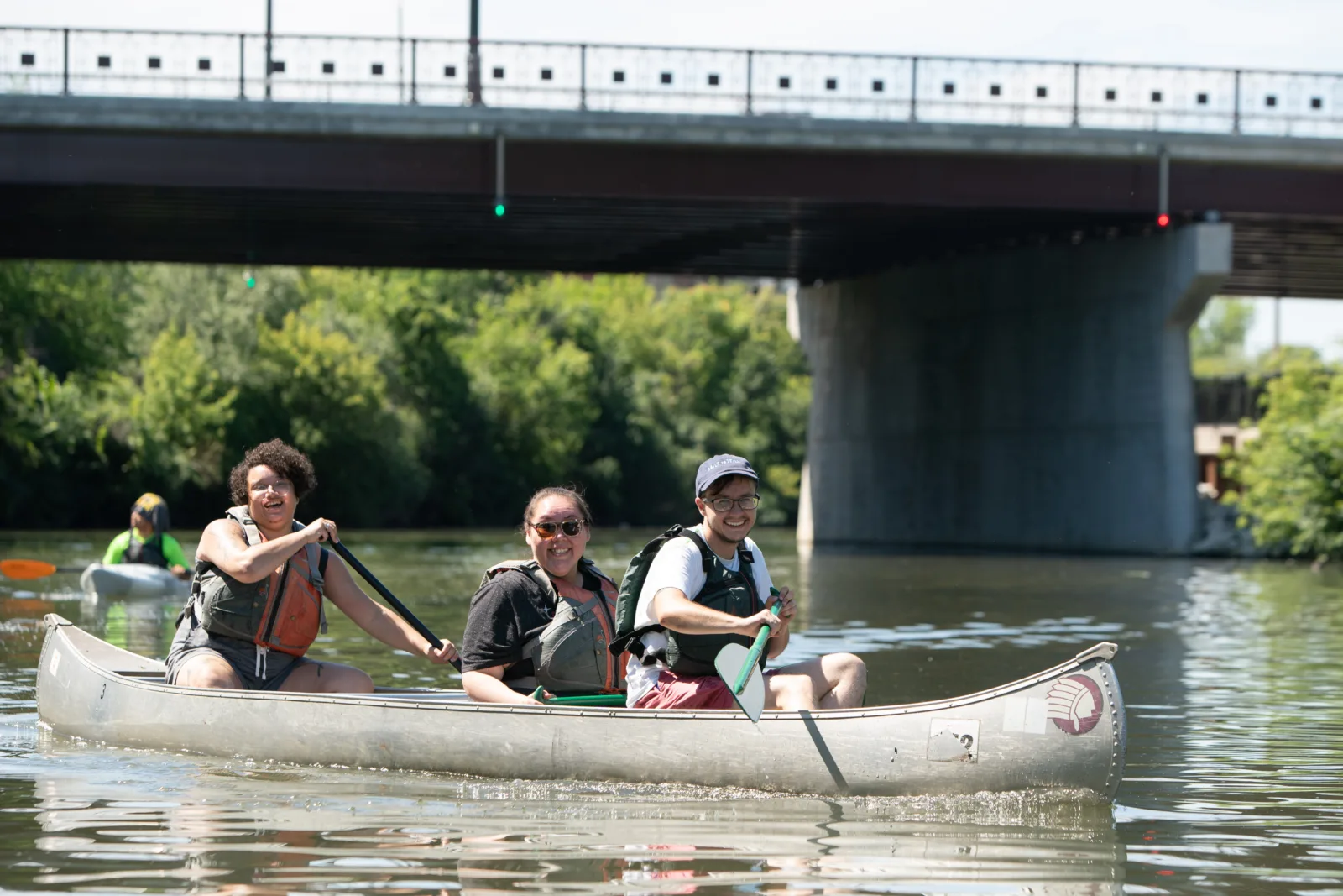 Smiling NCAIS participants paddle down the Chicago River.