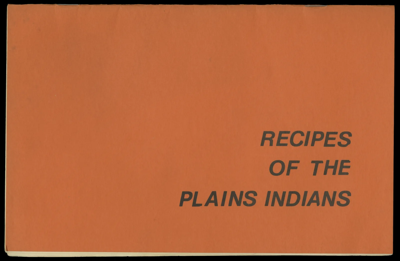 Recipes of the Plains Indians, cover A landscape-oriented pamphlet. The cover is orange and reads "Recipes of the Plains Indians."
