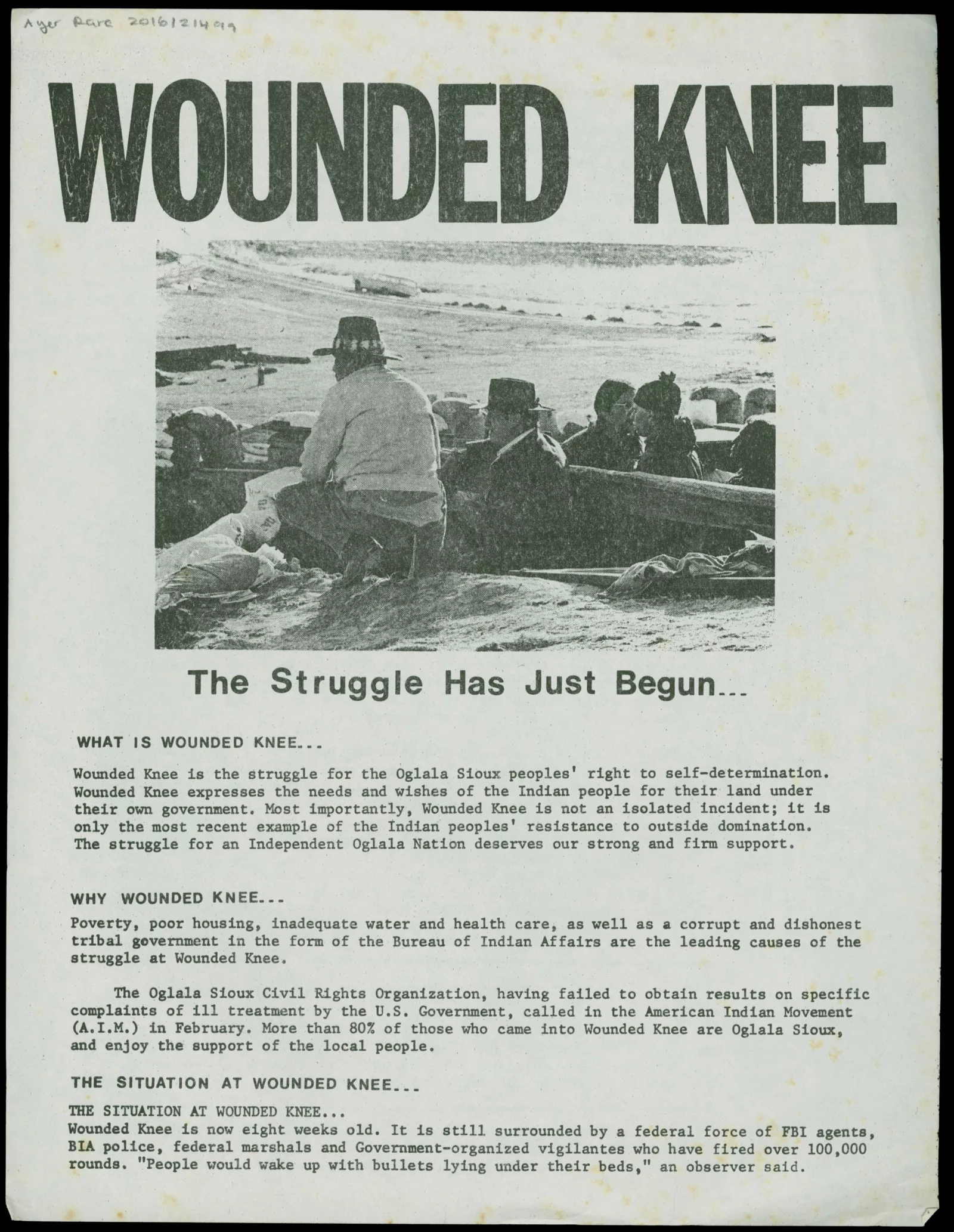 Black and white handbill with "Wounded Knee: The Struggle Has Just Begun..." at the top. An image of Oglala protestors is underneath the title.