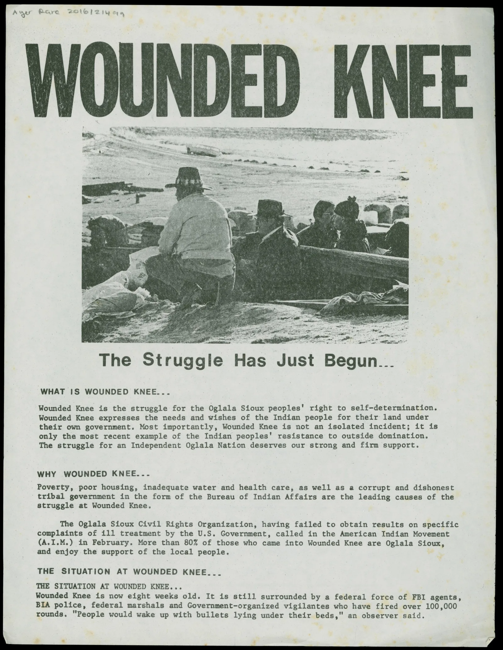 Wounded Knee Legal Defense/Offense Committee handbill: The Struggle Has Just Begun Black and white handbill with "Wounded Knee: The Struggle Has Just Begun..." at the top. An image of Oglala protestors is underneath the title.