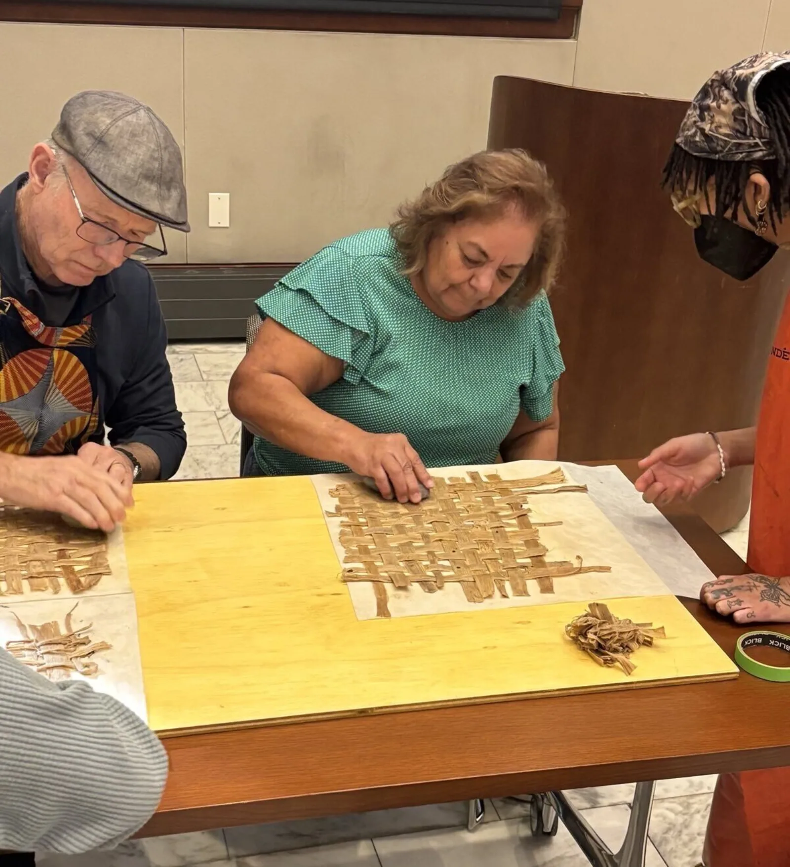 Patron Using Rock to Mash Bark Fibers into Amate Paper Patron Using Rock to Mash Bark Fibers into Amate Paper