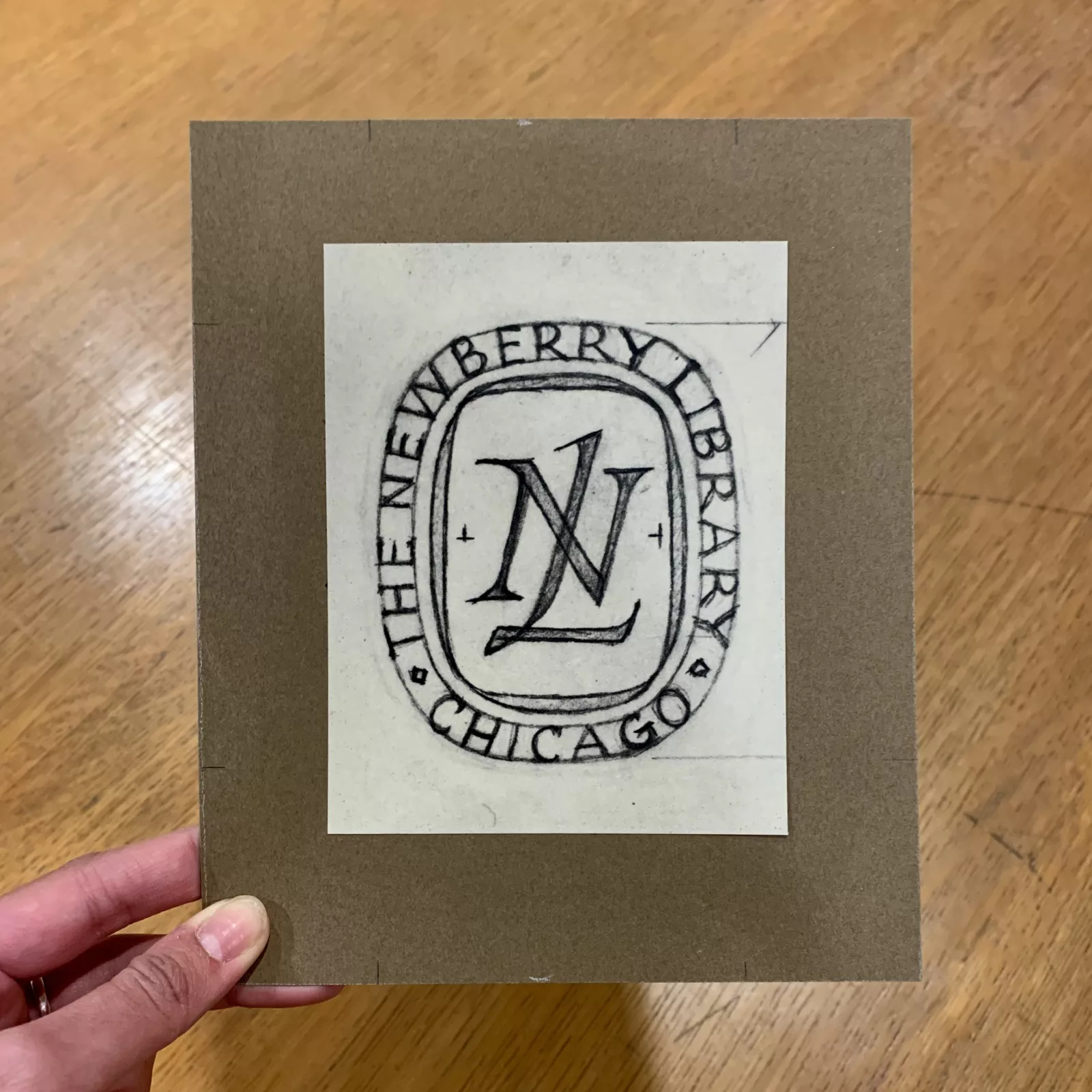 The logo has "NL" in the middle. "The Newberry Library, Chicago" is written around the perimeter.